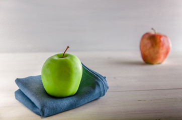 green apple on a white wooden background