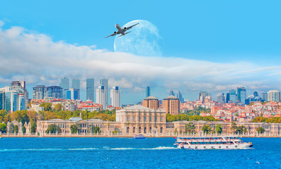 Airplane flying above the Dolmabahce palace with full moon - Istanbul, Turkey 
