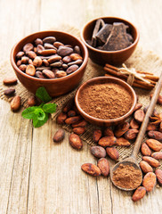 Natural  cocoa powder, chocolate and cocoa beans  on a wooden background