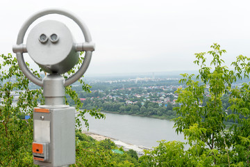 Observation deck for exploring the city. Binoculars for exploring the city close-up. Silver color telescope. Object out of focus