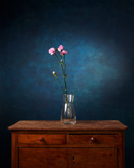 flower against the background of a painted background, old chest of drawers, empty space for the...