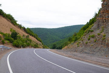 Highway in the mountains. Anapsky district of Russia. The nature is mountainous. low mountains. Turning road