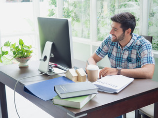 young man working at home ,businessman works on his computer to get all his business