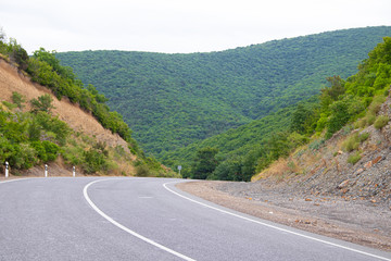Highway in the mountains. Anapsky district of Russia. The nature is mountainous. low mountains. Turning road