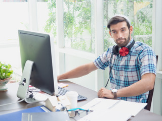 young man working at home with earphone ,businessman works on his computer to get all his business