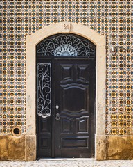 Old Portuguese door. Classic architecture from Portugal. Vintage cultural style.