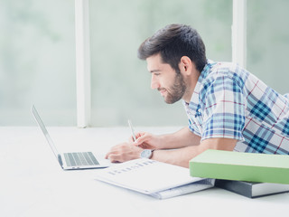 young man working at home   ,businessman works on his computer to get all his business