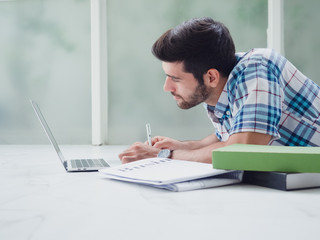 young man working at home   ,businessman works on his computer to get all his business