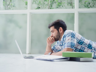 young man working at home   ,businessman works on his computer to get all his business