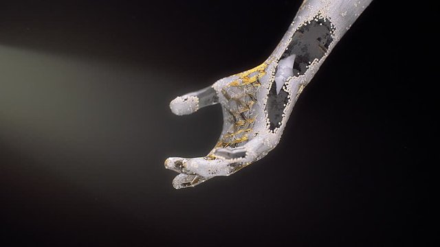 Stock motion graphics video shows a transparent glass hand slowly falling on a black background