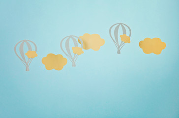 Mock up with paper clouds and flying balloons over blue pastel background