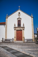 Old Portuguese street. Classic architecture and church from Portugal. Vintage cultural style.