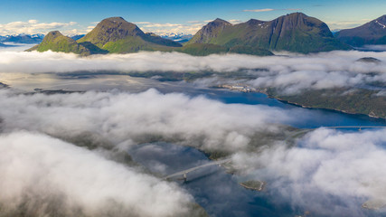 Fototapeta na wymiar Fish farm at sea. Waterfall. Fjord above the clouds. Aerial view. Norway