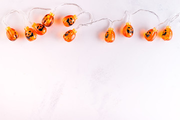 Halloween pumpkin background party lamps on white murble backgrounds,copy space,