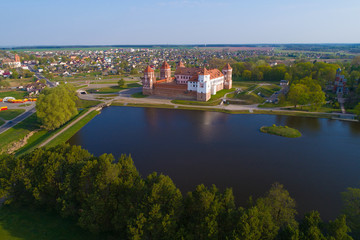 Fototapeta na wymiar The old Mir Castle in a spring morning landscape (aerial photography). Belarus