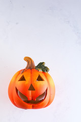 Halloween Pumpkin, funny Jack O'Lantern on white murble background, copy space