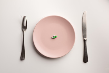 Medical capsules on a plate. Flat lay.