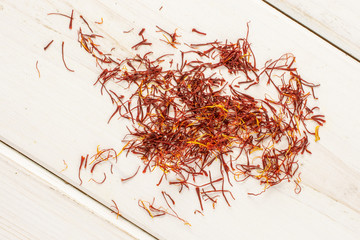 Fototapeta premium Lot of whole dry shaffron thread flatlay on white wood