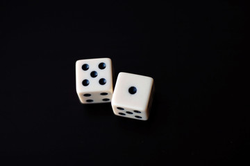 Two dice on a black background.