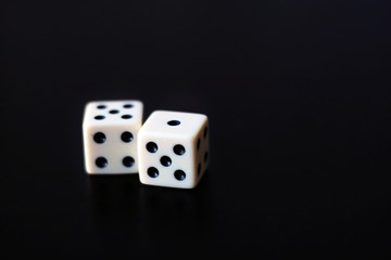 Two dice on a black background.