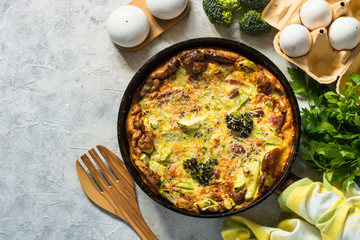 Frittata with sausage and vegetables in skillet.