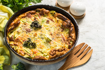 Obraz na płótnie Canvas Frittata with sausage and vegetables in skillet.
