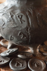  Runic pot on a wooden log 
