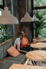 Obraz premium Young afro-american woman talking on mobile phone