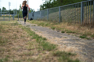 Young and fit woman doing an intensive sprint workout 