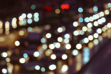 Defocused image of hard night for drivers. Big traffic in the city. In the summer urban highway...