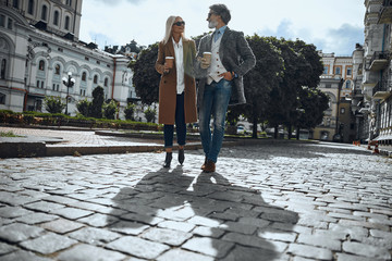 Pleasant stroll with coffee to go stock photo