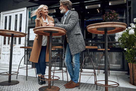Smiling couple at the cafe table outdoors stock photo
