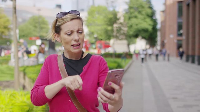 Young female using sign language on a video call as she walks in the city