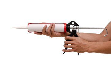 Men's hand holding Caulking gun and white silicone sealant