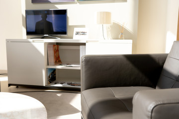 Interior of modern office in white and brown colors. Leather armchair, tv stand, sconces. Top-side view