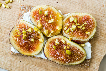 Crispbread with Fig, Ricotta Cheese, Pistachio and Honey Ready to Eat.