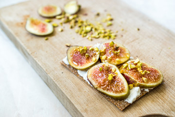 Crispbread with Fig, Ricotta Cheese, Pistachio and Honey Ready to Eat.
