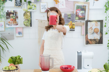 Beautiful girl holding a freshly made smoothie from berries. The concept of a healthy diet, healthy lifestyle.
