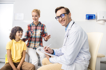 Obraz premium Happy doctor enjoying work with family stock photo