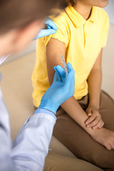Kid being treated with injection in hospital stock photo