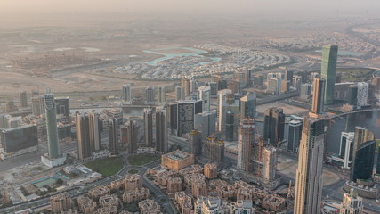 Fototapeta na wymiar Downtown of Dubai night to day timelapse before sunrise. Aerial view with towers and skyscrapers