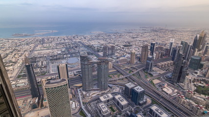 Fototapeta na wymiar Downtown of Dubai in the morning timelapse after sunrise. Aerial view with towers and skyscrapers