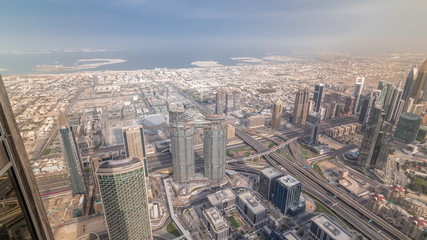 Downtown of Dubai in the morning timelapse after sunrise. Aerial view with towers and skyscrapers