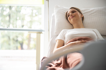 Beautiful young lady resting in hospital room