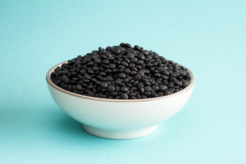 Fototapeta na wymiar Black Lentils in a Bowl