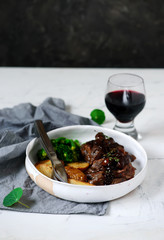 steak with mushroom sauce and potatoes.