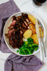 steak with mushroom sauce and potatoes.