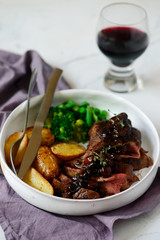 steak with mushroom sauce and potatoes.