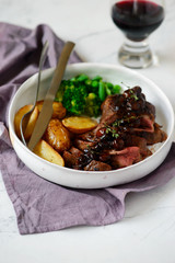 steak with mushroom sauce and potatoes.