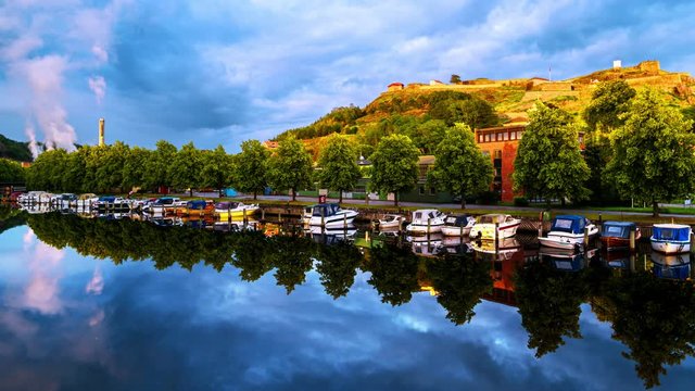 Halden, Norway. View of the boats and yachts with Fredriksted fortress at the background. Time-lapse in the evening with cloudy sky in summer